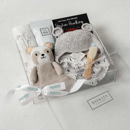 Gender neutral baby gift basket with clothing, plush panda, book, and swaddle is a Luxury newborn gift set with bear hat, bib, and bath products