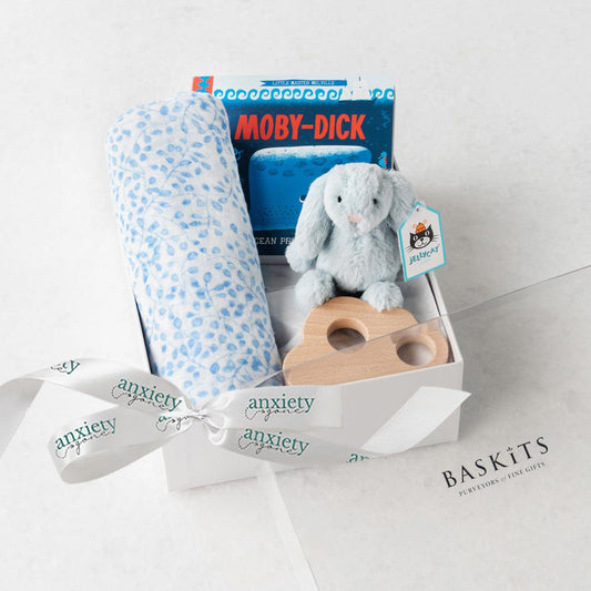 Blue new baby boy gift basket with swaddle, bunny, book, and teether for the perfect Bedtime snuggles gift set for newborn boys in keepsake box