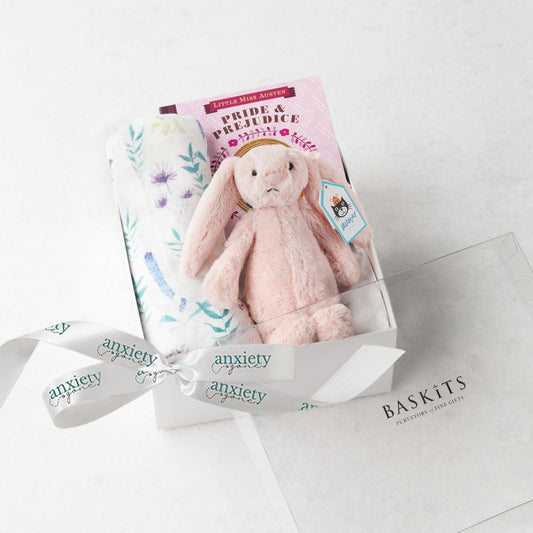 Pink new baby girl gift basket with swaddle, bunny, book, and teether, making it the perfect Bedtime snuggles gift set for newborn girls in keepsake box
