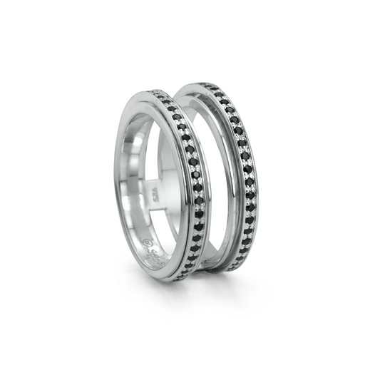 Sterling Silver Spinning Agoda Ring with black CZ stones and double band, displayed with complimentary tin and travel pouch