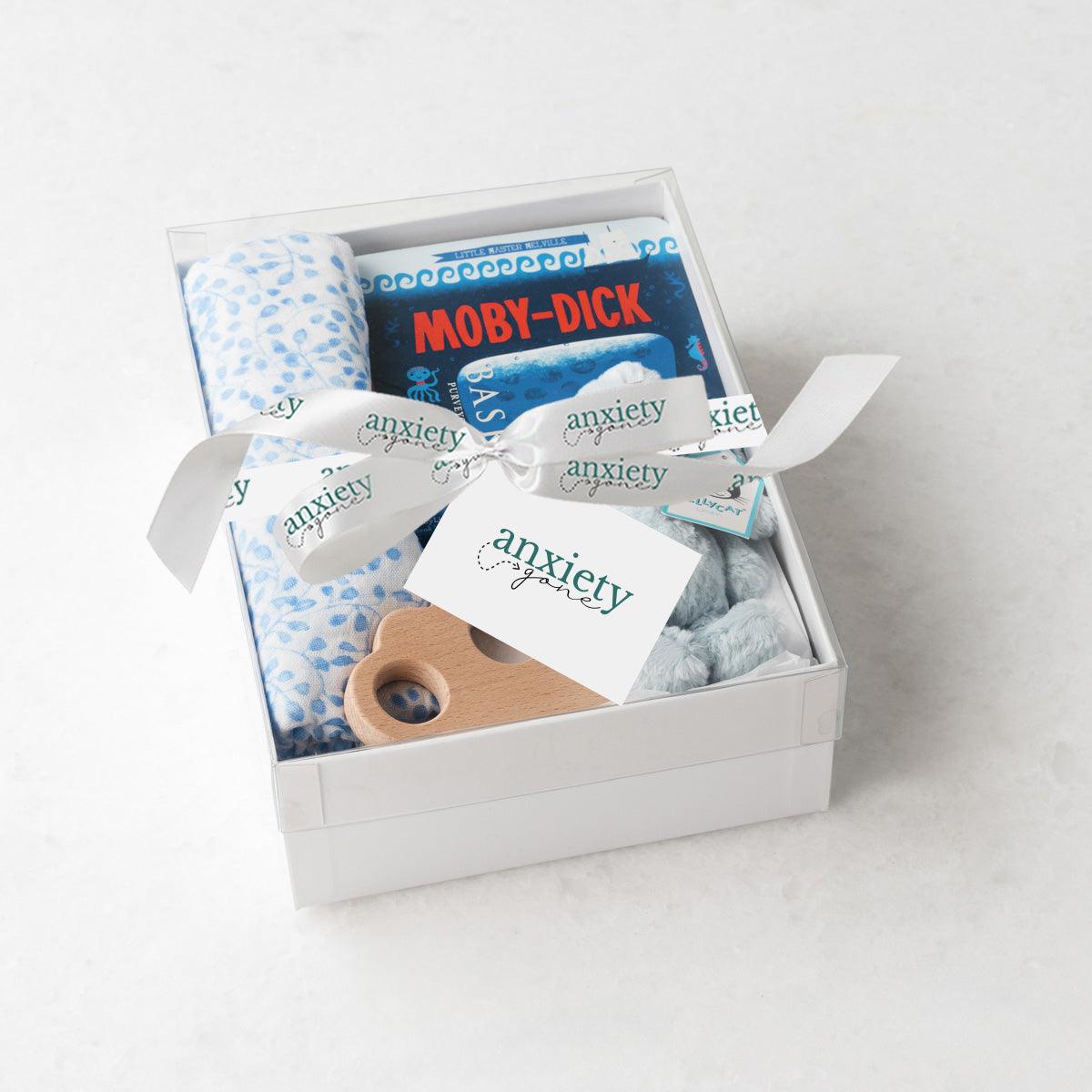 Blue new baby boy gift basket with swaddle, bunny, book, and teether for the perfect Bedtime snuggles gift set for newborn boys in keepsake box