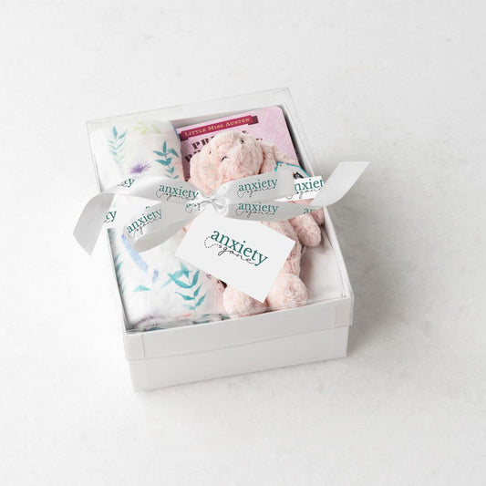Pink new baby girl gift basket with swaddle, bunny, book, and teether, making it the perfect Bedtime snuggles gift set for newborn girls in keepsake box