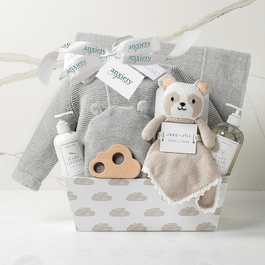 Gender neutral baby gift basket in gray with clothing, blanket, and plush is a Luxury newborn gift set with hat, sweater, lovie, and teether