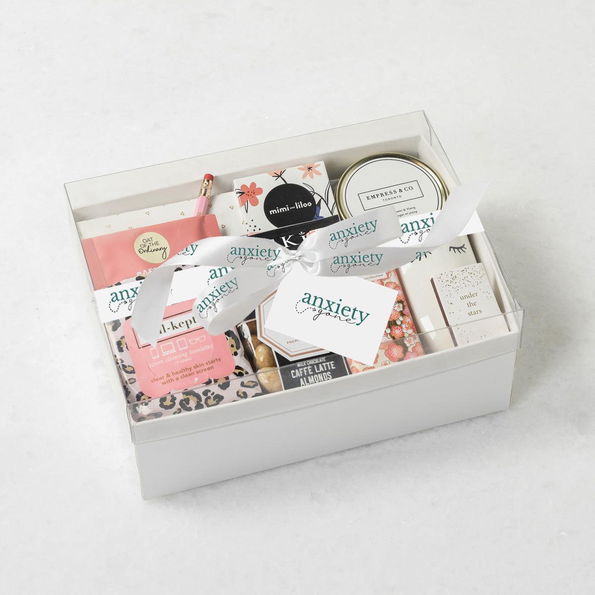 #BOSS Gift Box with luxury self-care items including chocolate, a candle, tea, snacks, and more, elegantly packaged in a keepsake box. Ideal for self-care gifts, thank i gift baskets, get well soon presents, and mental health gifts.