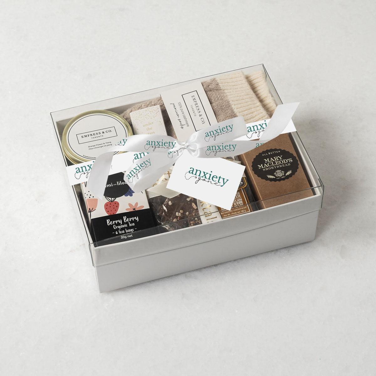 Simply the Best Gift Box featuring luxurious self-care items like milk chocolate, shortbread cookies, a scented candle, cashmere socks, and more—ideal for self-care gifts, thank i gift baskets, and mental health gifts.