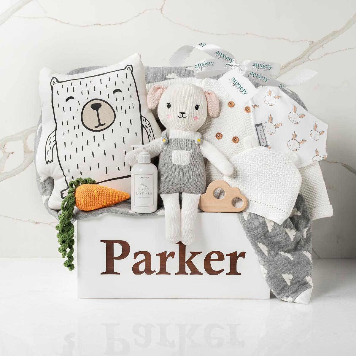 Personalized wooden toy box baby gift basket with clothing, blanket, and toys is the perfect Luxury gender neutral baby shower gift with keepsake wooden chest