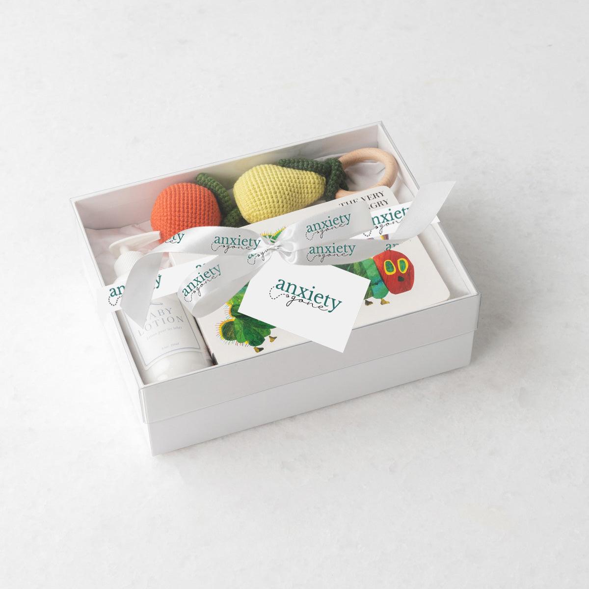 Very Hungry Caterpillar new baby gift basket with book and teethers is the perfect gender neutral baby shower gift set with natural baby items