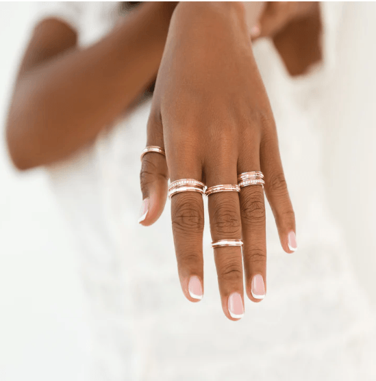 Stackable 14KT Rose Gold Vermeil Meditation Ring with white enamel spinning band, displayed with complimentary MeditationRings Tin and Travel Pouch