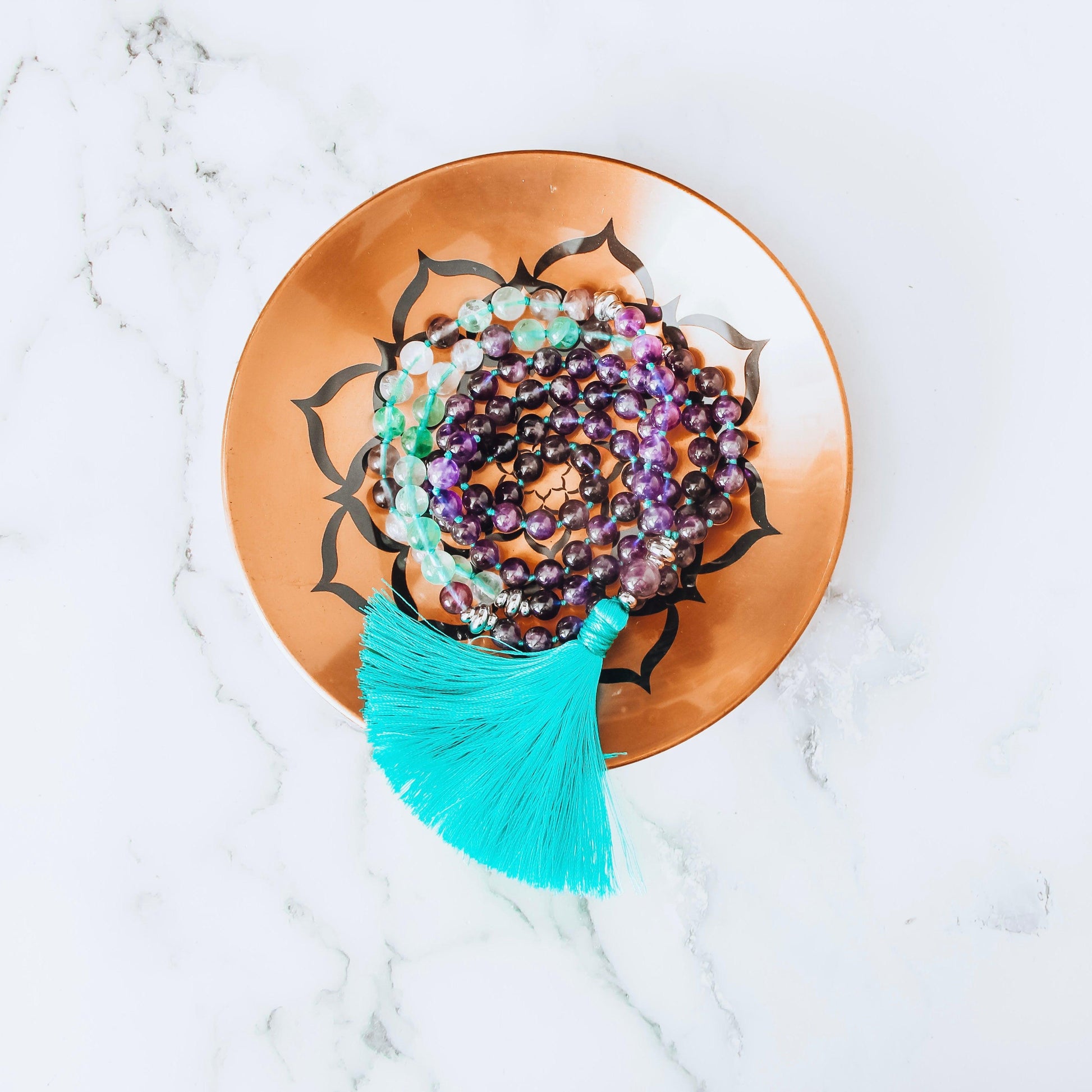 Awaken Amethyst and Green Fluorite Mala Necklace with 108 beads for spiritual healing and anxiety relief.