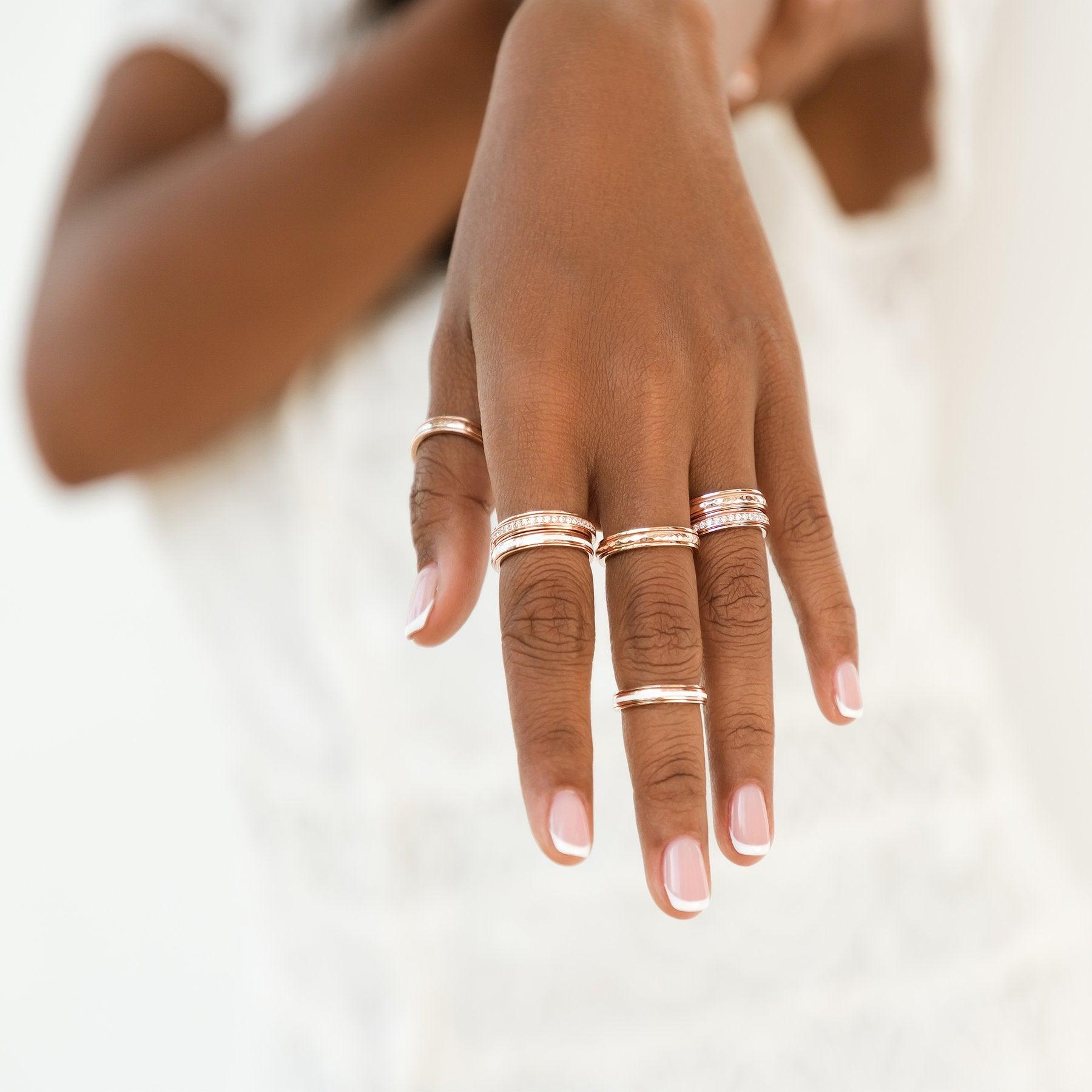 14 KT Rose Gold Vermeil Meditation Ring with spinning band adorned with clear CZ stones, displayed with complimentary MeditationRings Tin and Travel Pouch