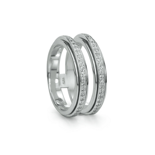Blessed spinning anxiety ring with sterling silver double band and clear CZ stones, displayed with complimentary tin and travel pouch