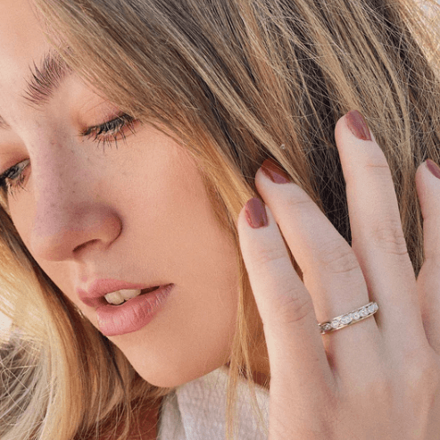 Devotion Meditation Agoda Ring in high-quality sterling silver with oval and marquise spinning band adorned with clear CZ stones, displayed with complimentary tin