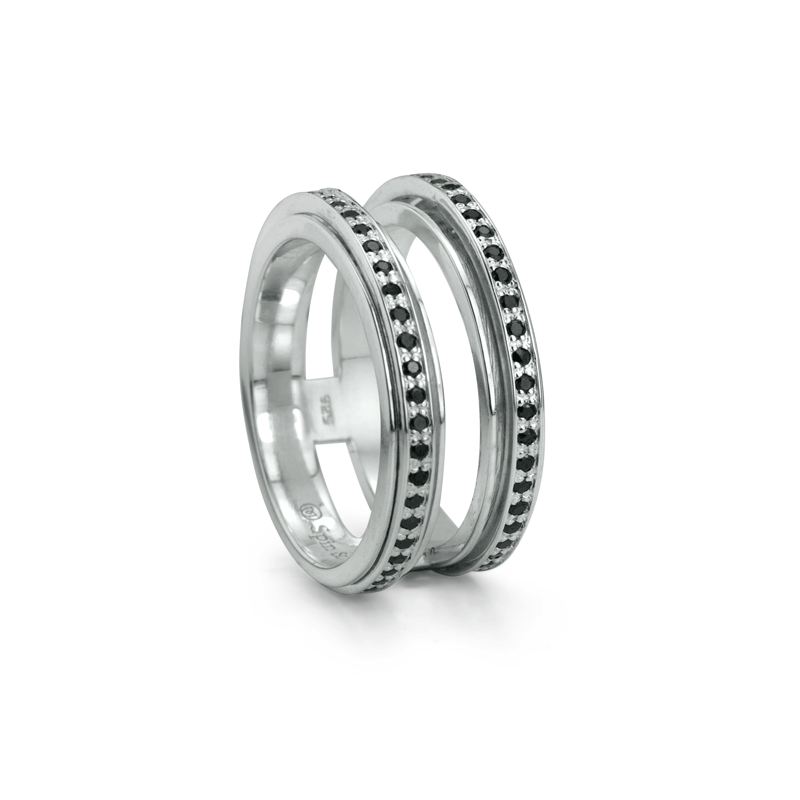 Sterling Silver Spinning Agoda Ring with black CZ stones and double band, displayed with complimentary tin and travel pouch